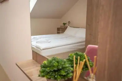 a bedroom with a bed and a table with plants at HARIZMA 013 in Kovin
