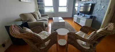 a living room with a couch and a table and chairs at Apartman Tea Belville in Belgrade
