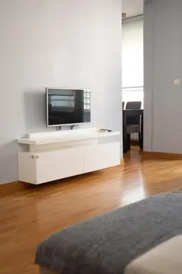 a white entertainment center with a flat screen tv on it at Apartman Tea Belville in Belgrade