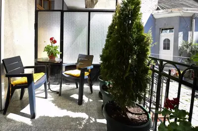 a balcony with a table and chairs and a christmas tree at Crown apartment - Your most comfortable stay in Belgrade