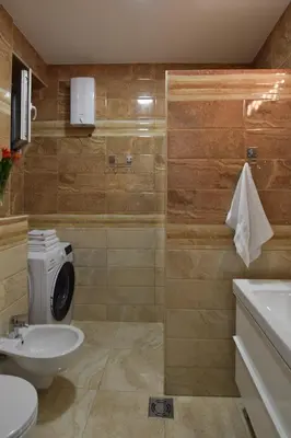 a bathroom with a toilet and a sink at Crown apartment - Your most comfortable stay in Belgrade