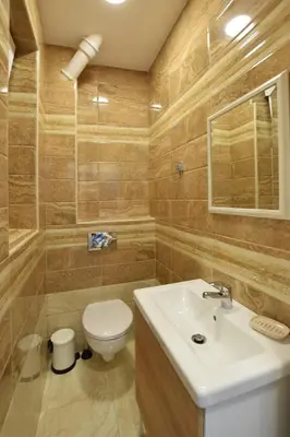 a bathroom with a toilet and a sink at Crown apartment - Your most comfortable stay in Belgrade