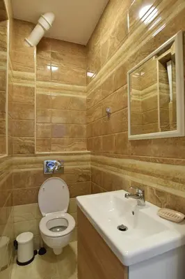 a bathroom with a toilet and a sink at Crown apartment - Your most comfortable stay in Belgrade