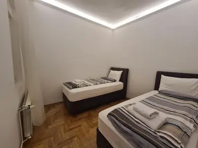 a small room with a bed and a small room with a bed sqor at Crown apartment - Your most comfortable stay in Belgrade