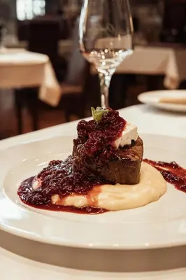 a piece of dessert on a white plate on a table at Hotel Topcider in Belgrade