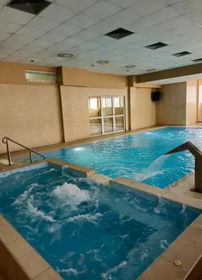 a large pool of blue water in a building at Hotel Slodes in Belgrade