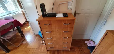 a wooden dresser with a television on top of it at Julija 2 in Pančevo