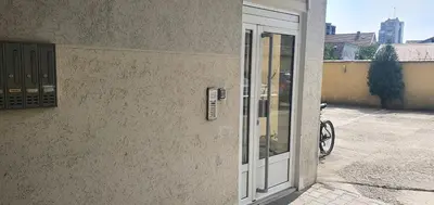 an open door of a building with a bike outside at Julija 2 in Pančevo