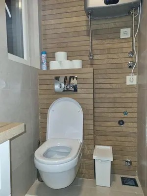 a small bathroom with a toilet and some towels at Apartment Nusic residence in Belgrade
