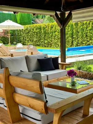 a patio with a couch and a table and a pool at Vila Aleksić in Smederevo