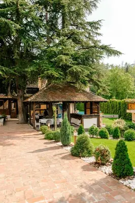 a gazebo in a garden with a tree at Vila Aleksić in Smederevo