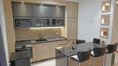 a kitchen with a table and chairs and a counter at Captain's Apartment in Karaburma