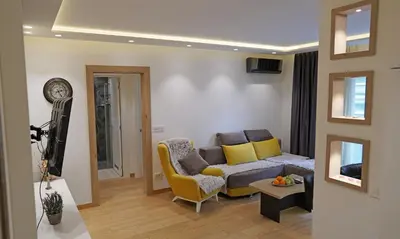 a living room with a couch and a chair at Captain's Apartment in Karaburma