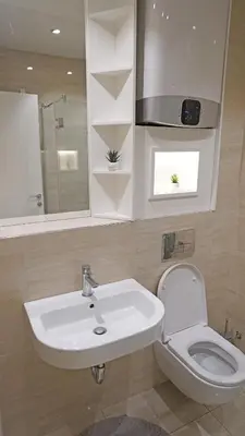 a bathroom with a sink and a toilet at Captain's Apartment in Karaburma