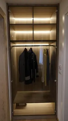 a walk in closet with clothes hanging in it at Captain's Apartment in Karaburma