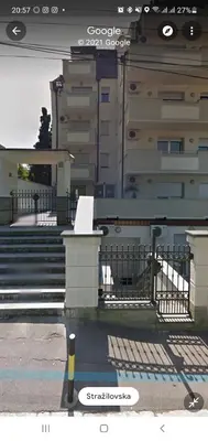 a sign on a railing in front of a building at Tennis studio in Belgrade