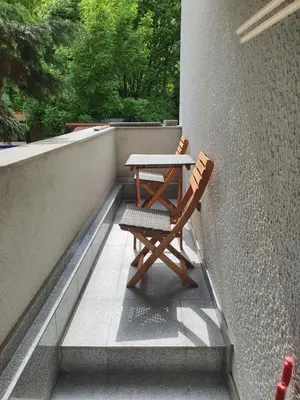 a table and two chairs sitting on a balcony at Tennis studio in Belgrade