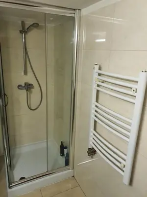 a shower with a glass door in a bathroom at Tennis studio in Belgrade