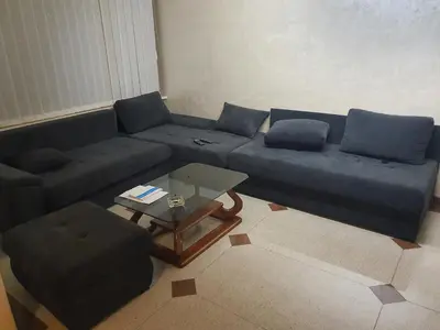 a living room with a blue couch and a coffee table at Tennis studio in Belgrade