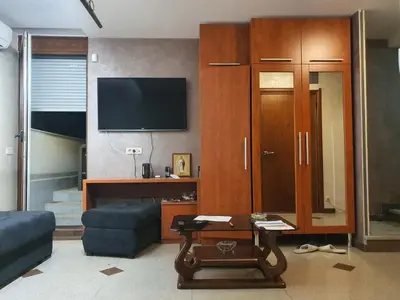 a living room with a couch and a tv at Tennis studio in Belgrade