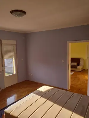 an empty room with a bed and a couch at Alex-Branka apartments in Zemun