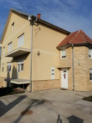 a building with a white door with a cross on it at Alex-Branka apartments in Zemun