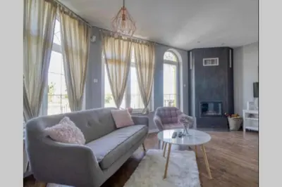 a living room with a couch and a table at Villa Danube , 25 min from Belgrade, 20 min Airport, Private Pool & Sauna in Novi Banovci