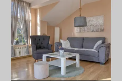 a living room with a couch and a table at Villa Danube , 25 min from Belgrade, 20 min Airport, Private Pool & Sauna in Novi Banovci