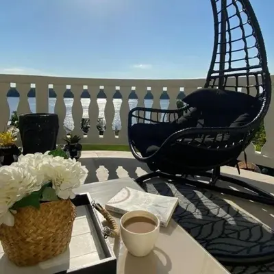 a table with a basket of flowers and two chairs at Villa Danube , 25 min from Belgrade, 20 min Airport, Private Pool & Sauna in Novi Banovci