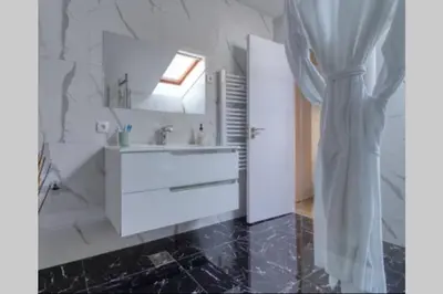 a white bathroom with a sink and a mirror at Villa Danube , 25 min from Belgrade, 20 min Airport, Private Pool & Sauna in Novi Banovci
