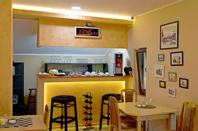 a kitchen with a yellow bar with a table and chairs at Vila Chess in Belgrade