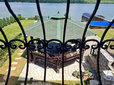 a view of a table and a bench through a gate at San na vodi in Smederevo