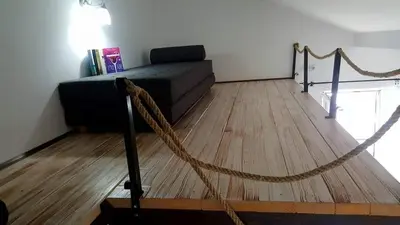 a living room with a couch and a rope at San na vodi in Smederevo