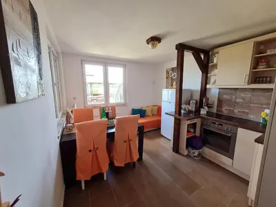 a kitchen with a table and chairs and a dining room at San na vodi in Smederevo
