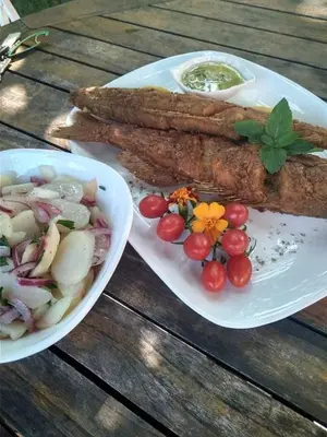 a table with two plates of food and a bowl of vegetables at San na vodi in Smederevo