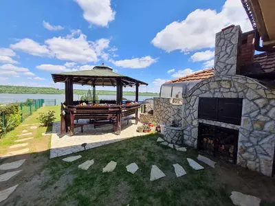 a gazebo with a picnic table and a fireplace at San na vodi in Smederevo