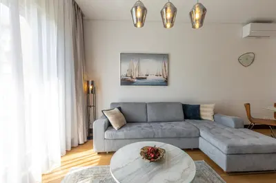 a living room with a couch and a table at Belgrade Center Apartment Lux in Belgrade