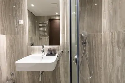 a bathroom with a sink and a shower at Belgrade Center Apartment Lux in Belgrade