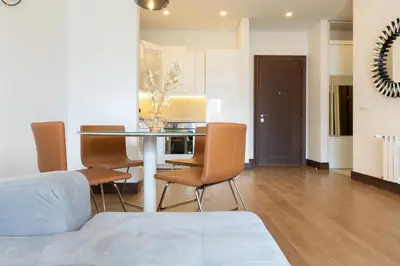 a kitchen and dining room with a table and chairs at Belgrade Center Apartment Lux in Belgrade