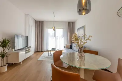 a living room with a table and a couch at Belgrade Center Apartment Lux in Belgrade