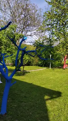 a blue sculpture of a tree in a park at Šumski Raj- Forest Paradise in Velika Remeta