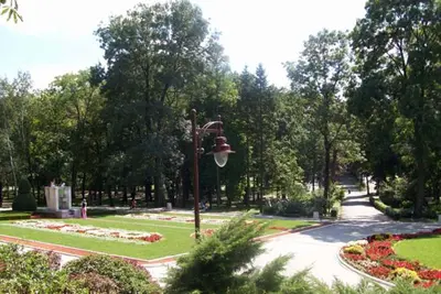 a park with a street light and a garden with flowers at APARTMAN U BUKOVICKOJ BANJI ARANDJELOVAC in Arandjelovac