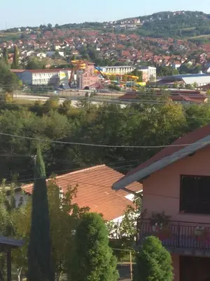a view of a city from a roof of a house at APARTMAN U BUKOVICKOJ BANJI ARANDJELOVAC in Arandjelovac