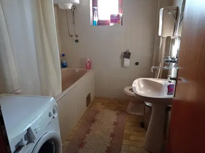 a bathroom with a washing machine and a sink at APARTMAN U BUKOVICKOJ BANJI ARANDJELOVAC in Arandjelovac