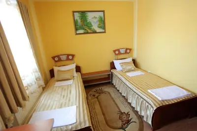 two twin beds in a room with a window at Villa Atina in Stara Pazova