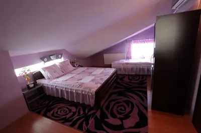 a small bedroom with a bed and a window at Villa Atina in Stara Pazova