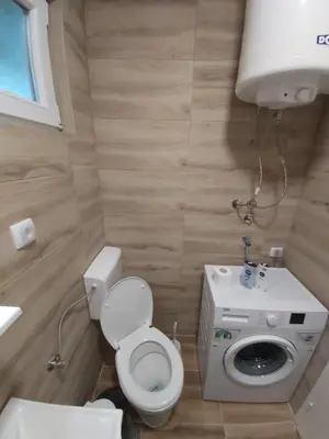 a small bathroom with a toilet and a sink at APARTMAN TEA 2 in Belgrade