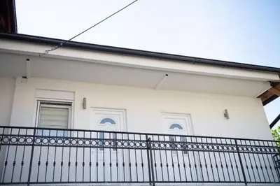 a white house with a black fence at APARTMAN TEA 2 in Belgrade