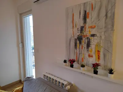 a painting on a wall with plants on a shelf at Yellow Gate in Novi Grad