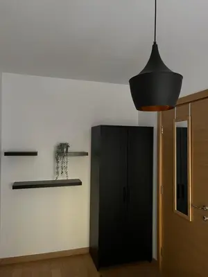 a kitchen with a black cabinet and aendant light at Yellow Gate in Novi Grad